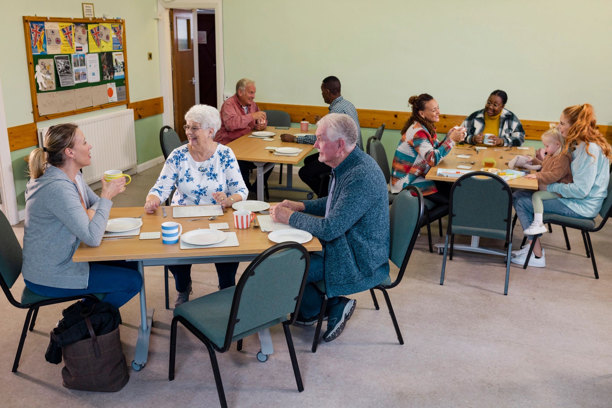 Community members gathering in a warm and friendly local support hub